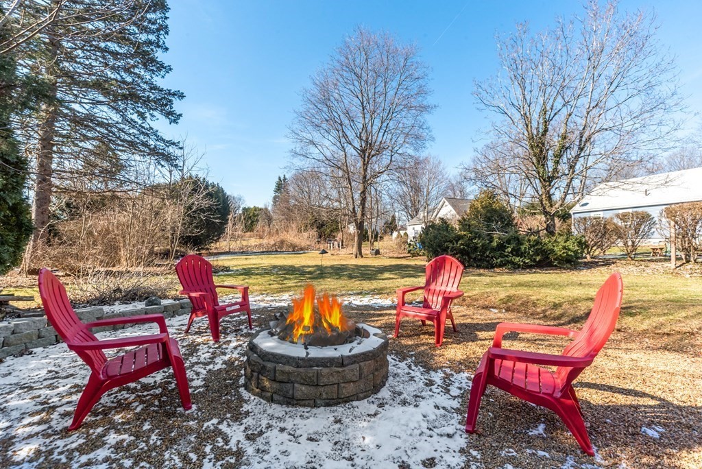 112 Elmwood Street Auburn, MA 01501 - Photo 5 of 40 a backyard of a house with fire pit and outdoor seating