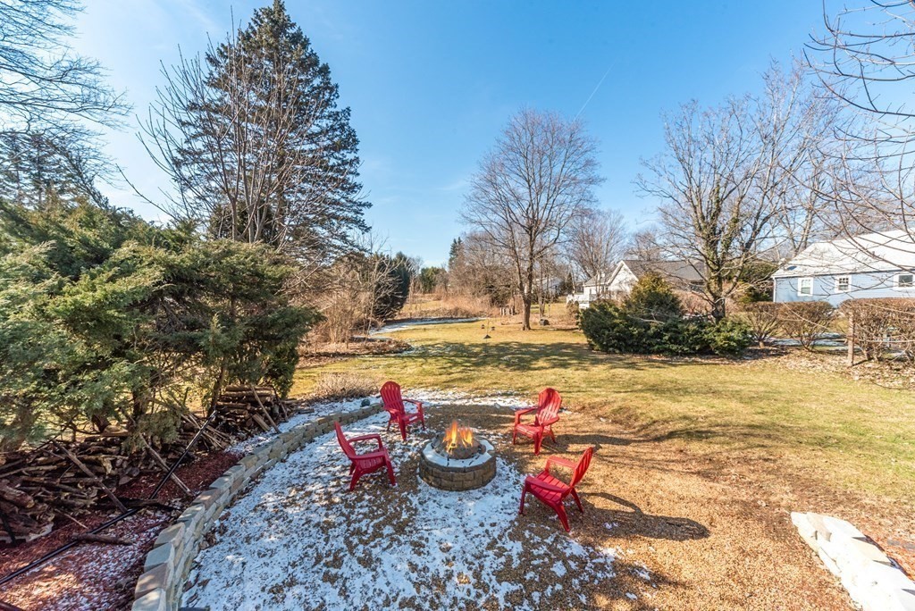 112 Elmwood Street Auburn, MA 01501 - Photo 7 of 40 a view of a backyard with fountain plants and large trees