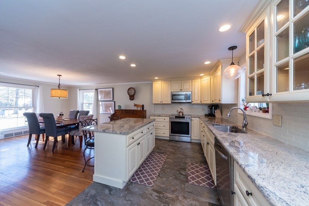 112 Elmwood Street Auburn, MA 01501 - Photo 10 of 40 a large kitchen with a table and chairs