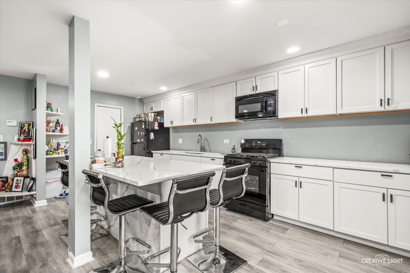 950 Jefferson Avenue, Unit B Elgin, IL 60120 - Photo 4 of 10 a kitchen with a stove top oven and cabinets