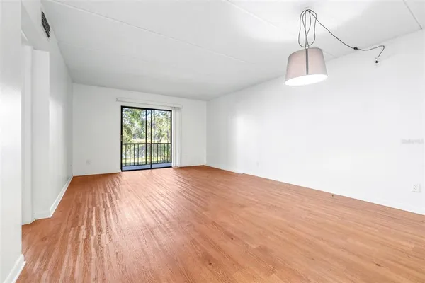 a view of a kitchen with wooden floor and a chandelier