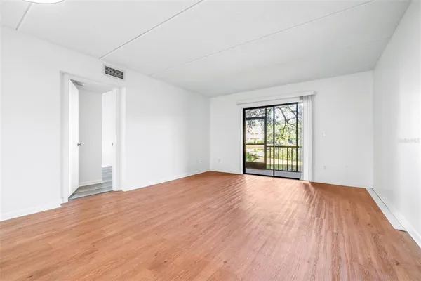 a view of a kitchen with a wooden floor and a window
