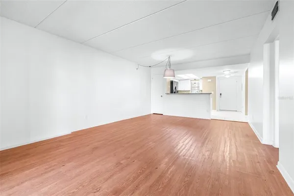 a view of an empty room and wooden floor