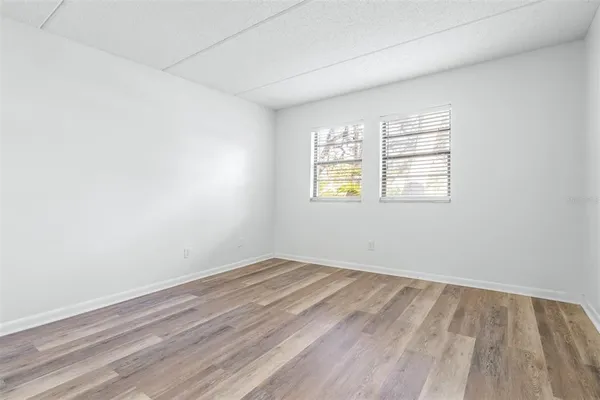 a view of a workspace with furniture and wooden floor