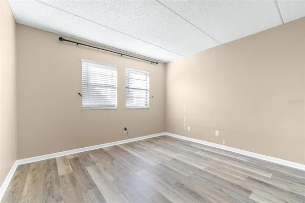 a view of a brick house with large windows