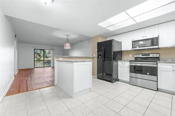 a kitchen with stainless steel appliances a sink and a refrigerator