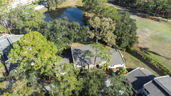 an aerial view of a house with a yard