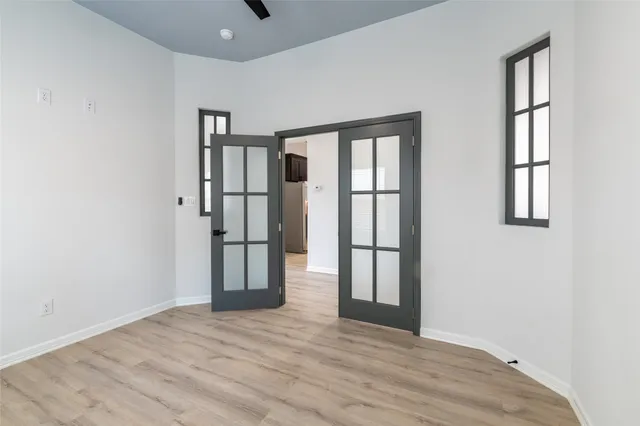 an empty room with windows and closet