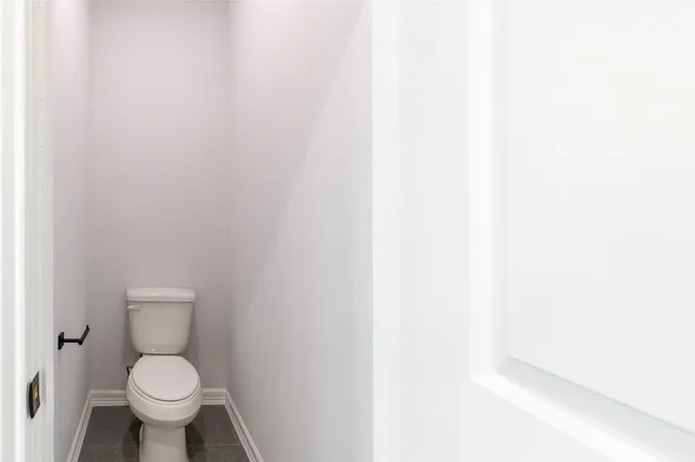 a white toilet sitting in a bathroom