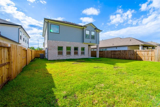 a view of a house with a garden and yard