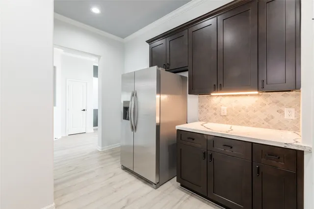a kitchen with stainless steel appliances granite countertop a refrigerator and a sink