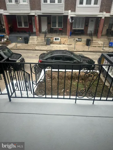 a view of building with car parked