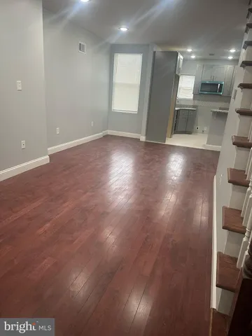 a view of a room with wooden floor