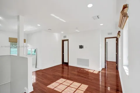 a view of an empty room and wooden floor