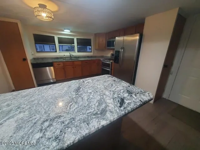 an empty room with wooden floor and mirror