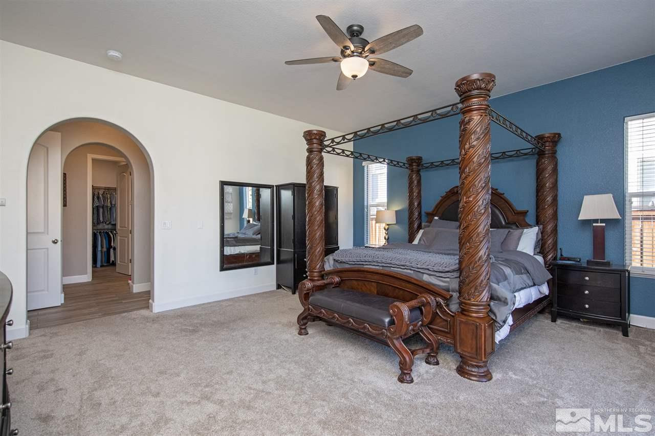 8345 Fairway Ridge Court Reno, NV 89523 - Photo 21 of 40 a bedroom with bed and a chandelier
