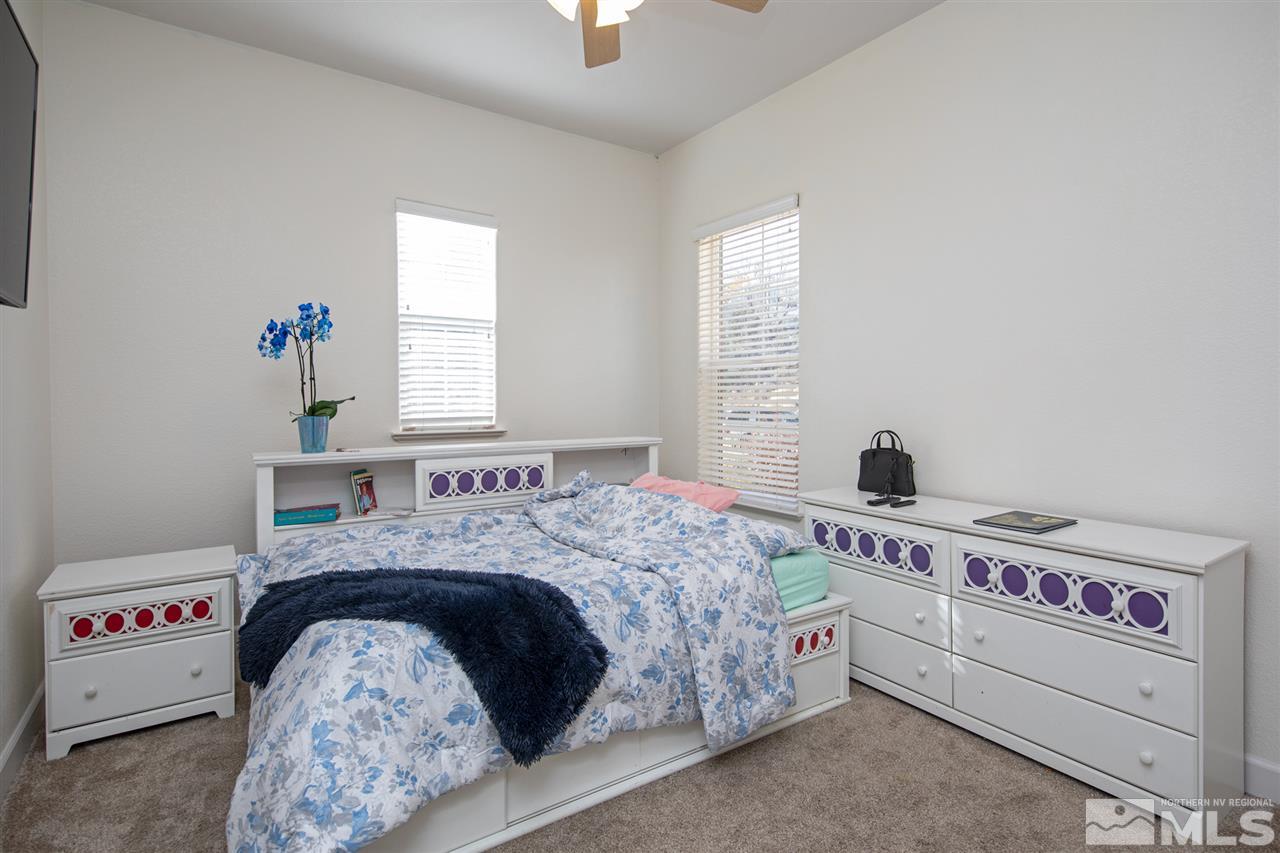 8345 Fairway Ridge Court Reno, NV 89523 - Photo 25 of 40 a bedroom with a bed and a chandelier