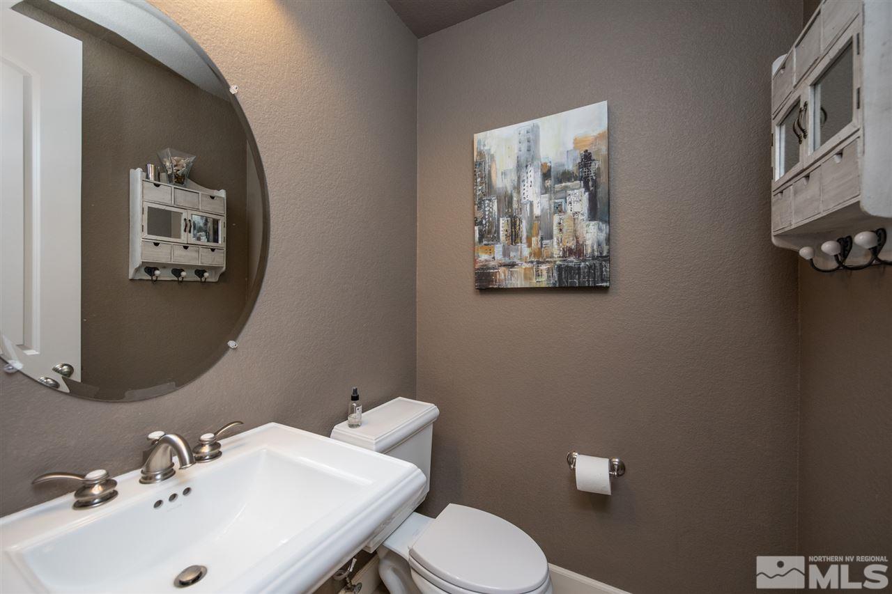 8345 Fairway Ridge Court Reno, NV 89523 - Photo 30 of 40 a bathroom with a toilet sink and mirror