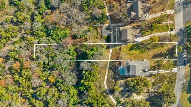 a view of a balcony with a floor to ceiling window and tree