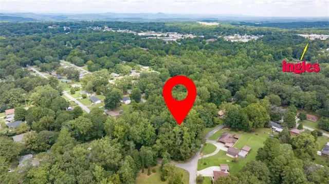 an aerial view of a house with a backyard space