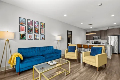 a living room with furniture and wooden floor