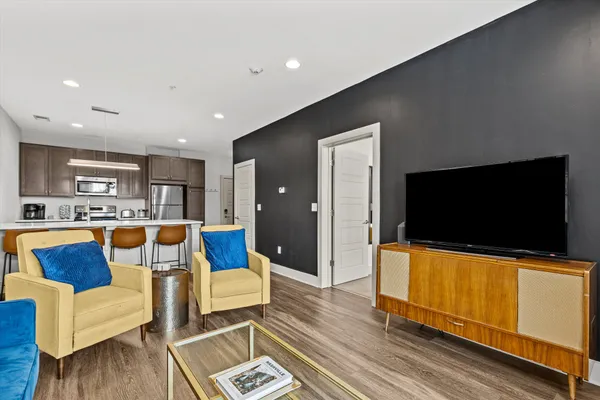 a living room with furniture and a flat screen tv