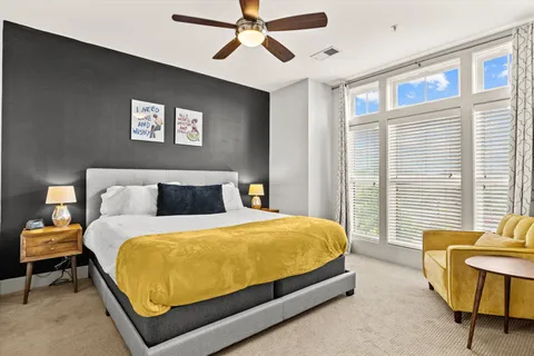 a bed sitting in a bedroom next to a window