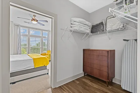 a view of a room with wooden floor and cabinet