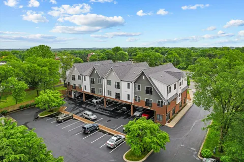 an aerial view of a house with a big yard
