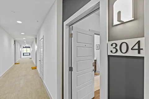 a view of a hallway with wooden shelves