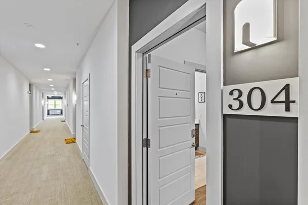 a view of a hallway with wooden shelves