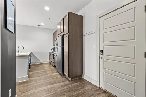 a view of a hallway with wooden floor