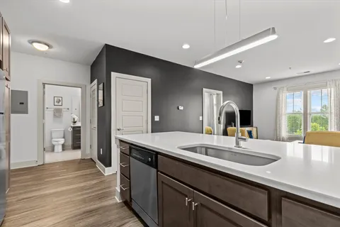 a kitchen with sink refrigerator and large window