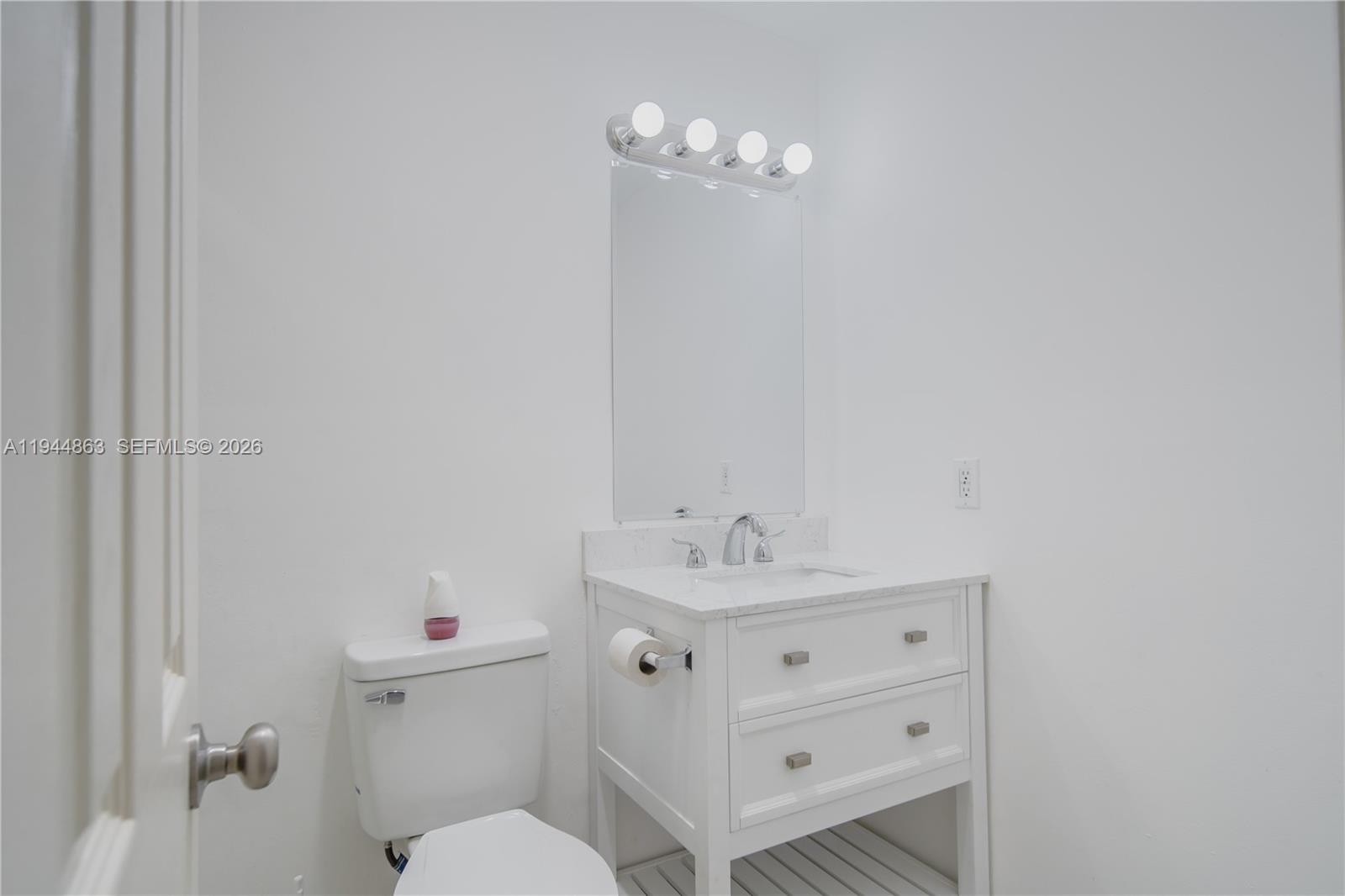 2830 Riverside Drive, Unit 2013 Coral Springs, FL 33065 - Photo 11 of 14 a bathroom with a sink a toilet and a mirror