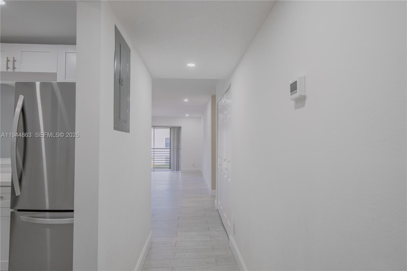 2830 Riverside Drive, Unit 2013 Coral Springs, FL 33065 - Photo 3 of 14 a view of a refrigerator in kitchen and an empty room