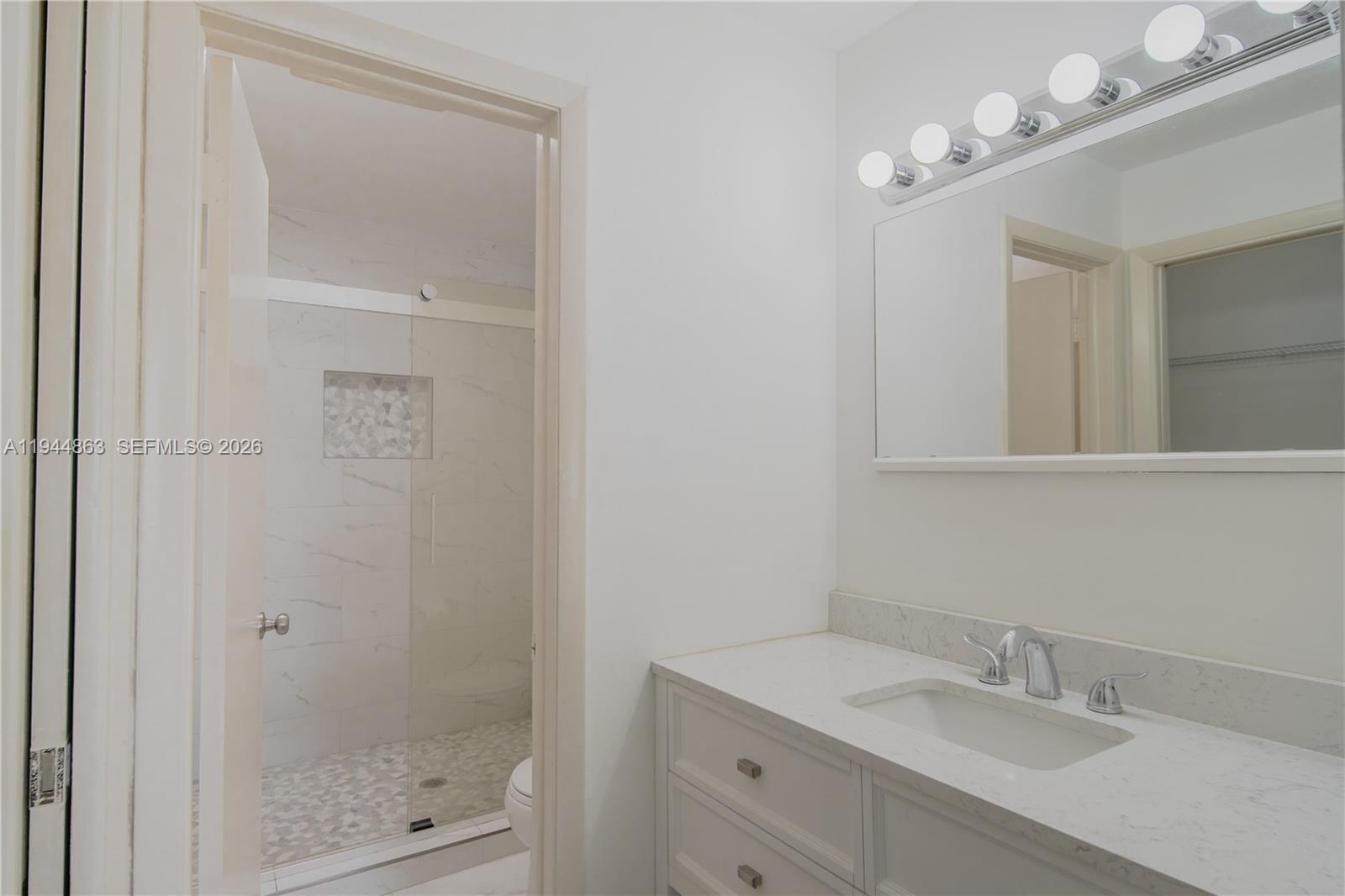 2830 Riverside Drive, Unit 2013 Coral Springs, FL 33065 - Photo 8 of 14 a bathroom with a shower a sink and mirror