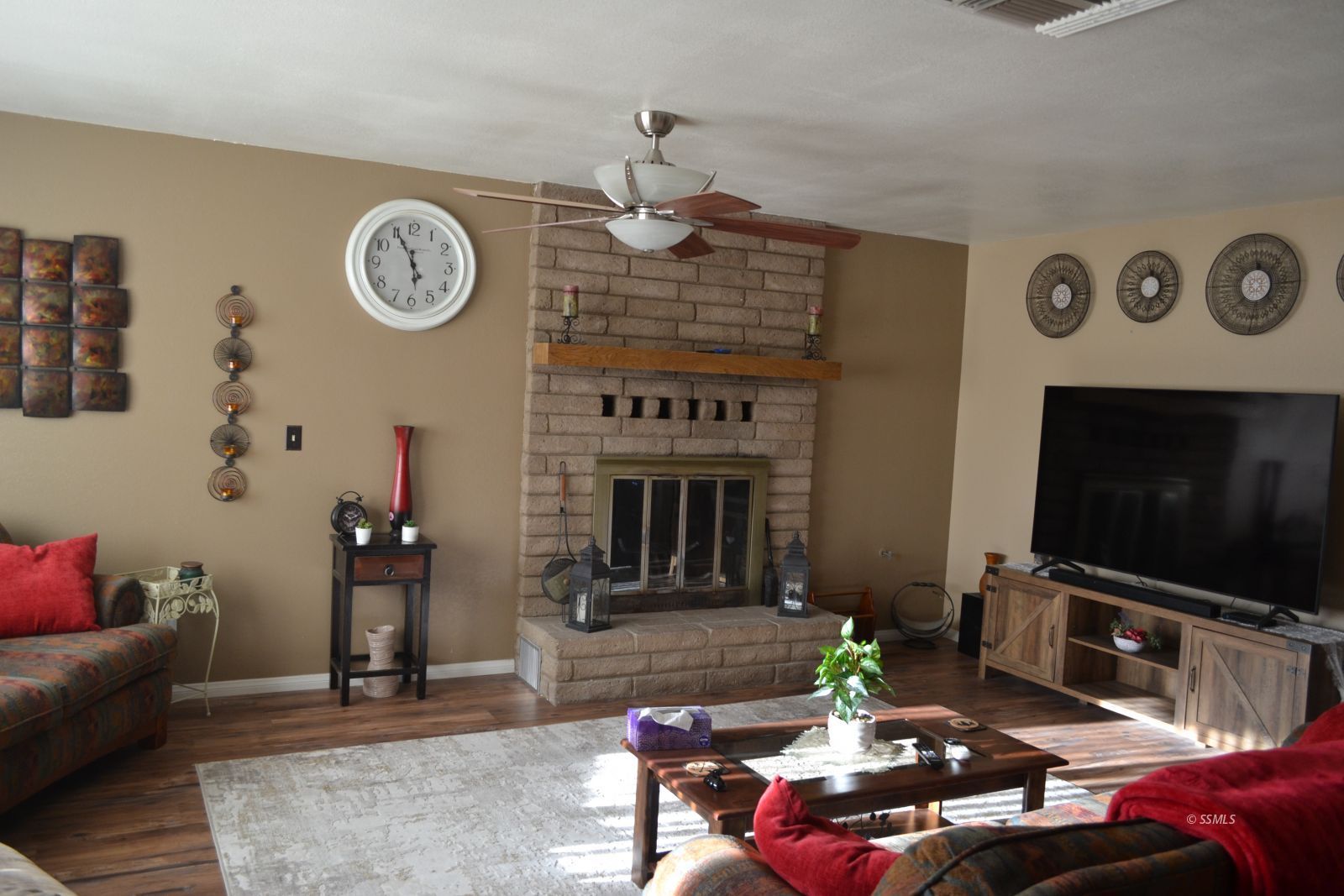 429 South Fountain Street Ridgecrest, CA 93555 - Photo 29 of 33 a living room with furniture a flat screen tv and a clock
