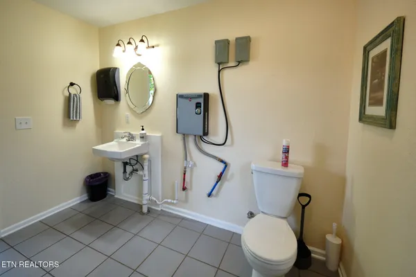 a bathroom with a sink mirror and a shower