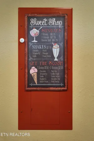 a kitchen with stainless steel appliances granite countertop a stove a sink and a refrigerator with wooden cabinets