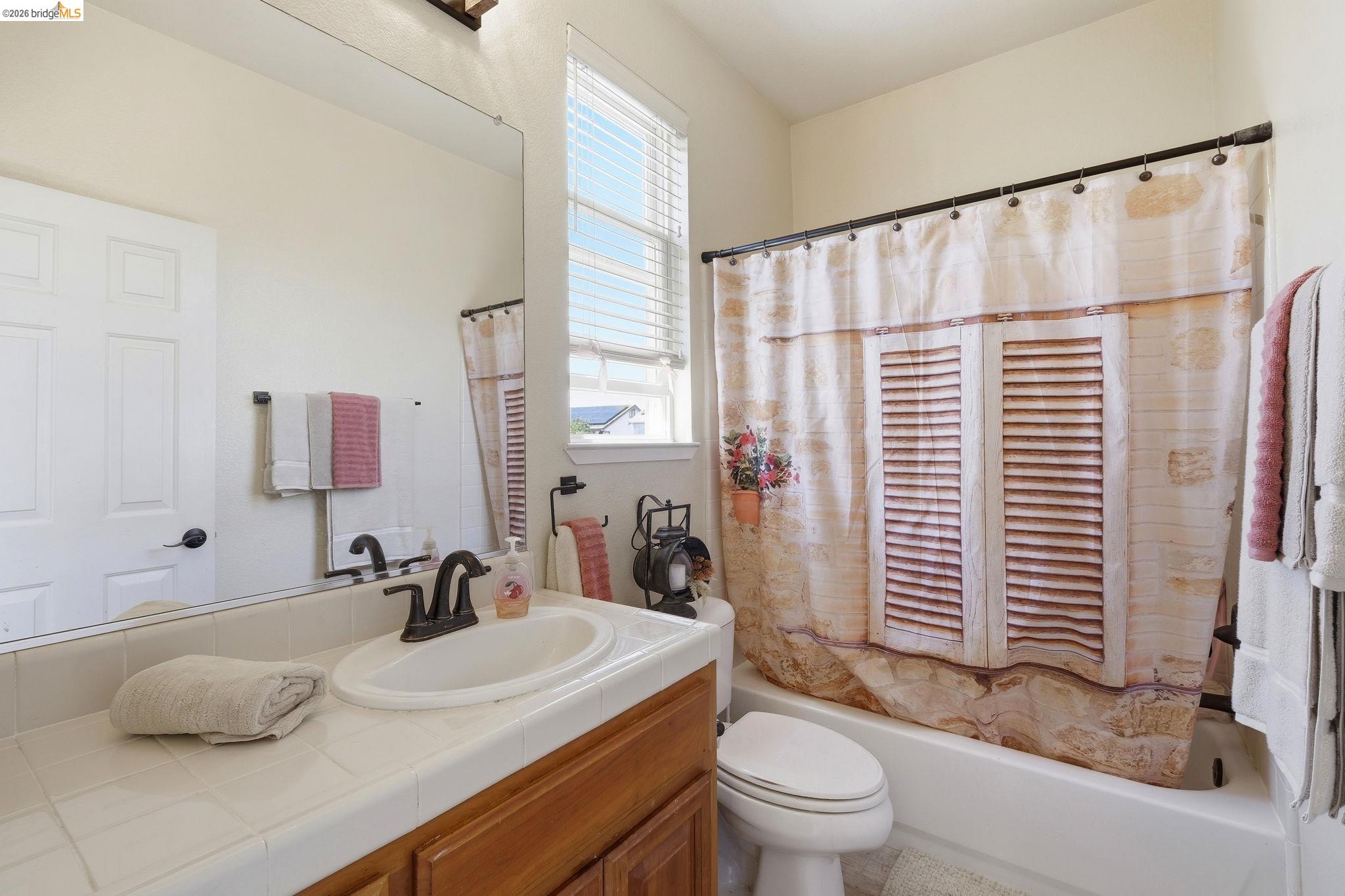 3438 Keystone Loop Discovery Bay, CA 94505 - Photo 39 of 57 a bathroom with a sink and a mirror