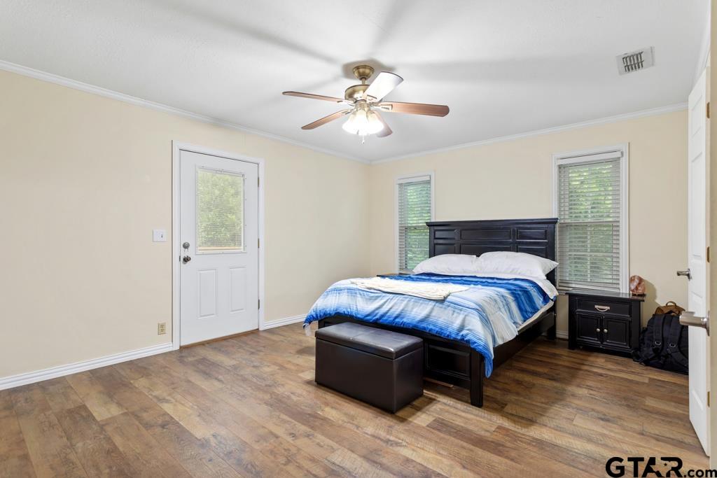 448 North Hill Road Tyler, TX 75706 - Photo 15 of 30 a bedroom with a bed and a chandelier