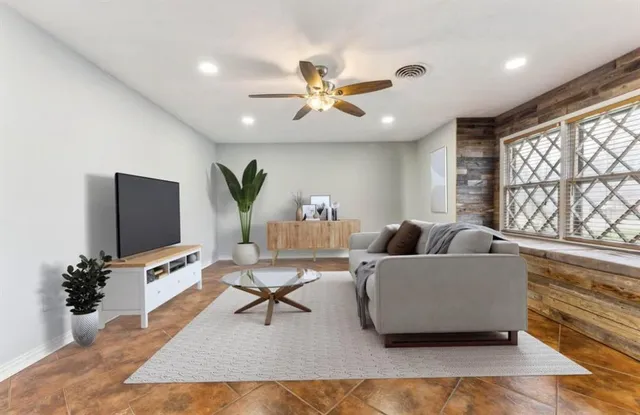 a living room with furniture and a flat screen tv