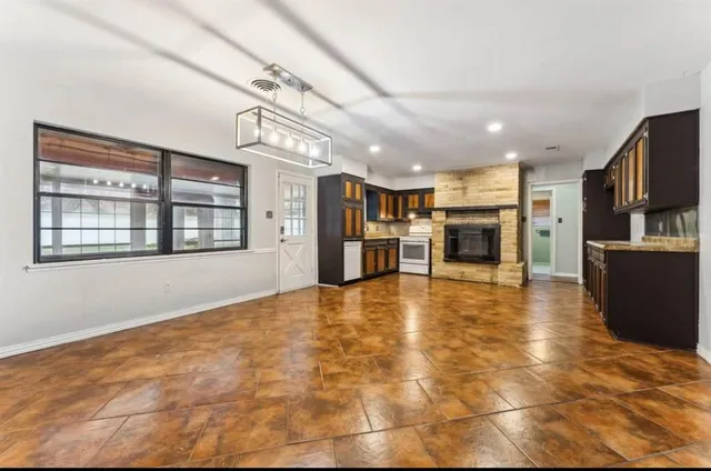 a view of kitchen with stainless steel appliances cabinets and flat screen tv