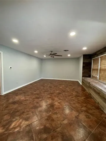 a large kitchen with kitchen island a counter top a stove and a refrigerator