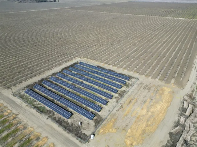 a view of a yard with wooden fence