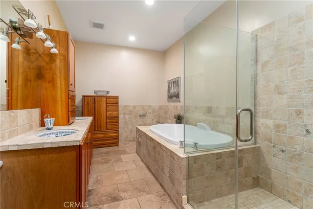 a bathroom with a tub sink and mirror