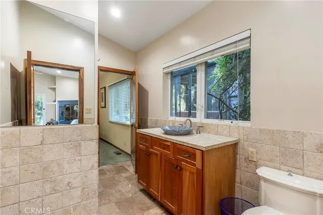 a bathroom with a granite countertop sink and a mirror