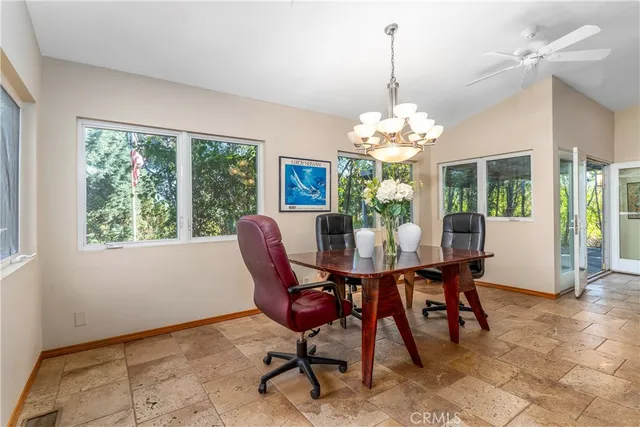 a view of a dining room with furniture and chandelier