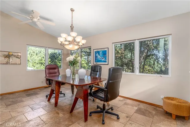 a dining room with furniture a window and a chandelier