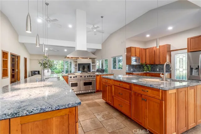 a large kitchen with kitchen island a large island in the center and stainless steel appliances